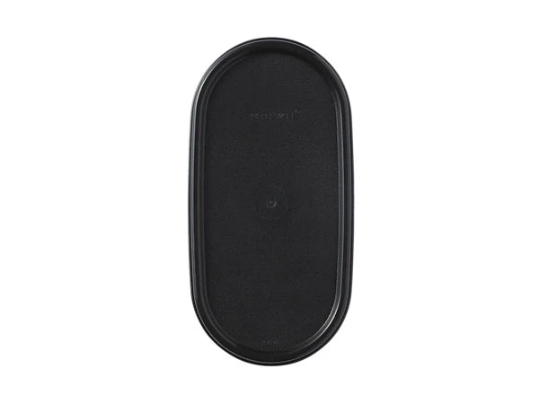 Black oval tupperware lid on white background