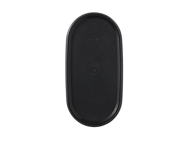 Black oval tupperware lid on white background