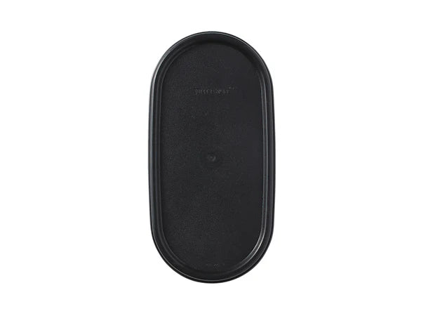 Black plastic oval tupperware lid on white background