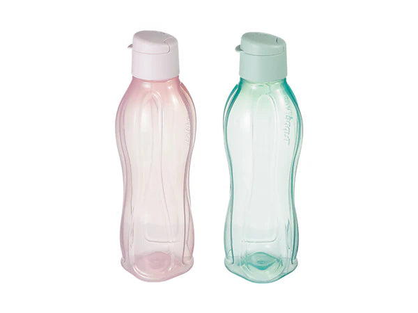 Two plastic bottles, one pink and one green, on a white background