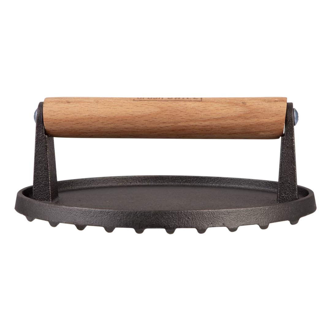Black cast iron grill press with wooden handle on a white background