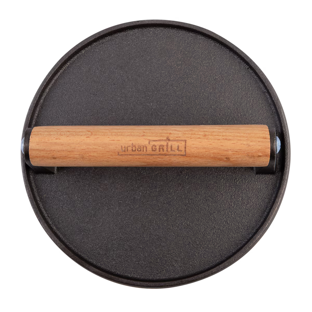Black round grill press with wooden handle on a white background