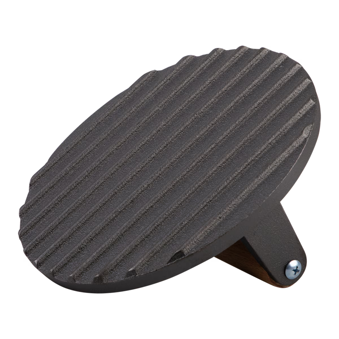 Black cast iron grill press on a white background