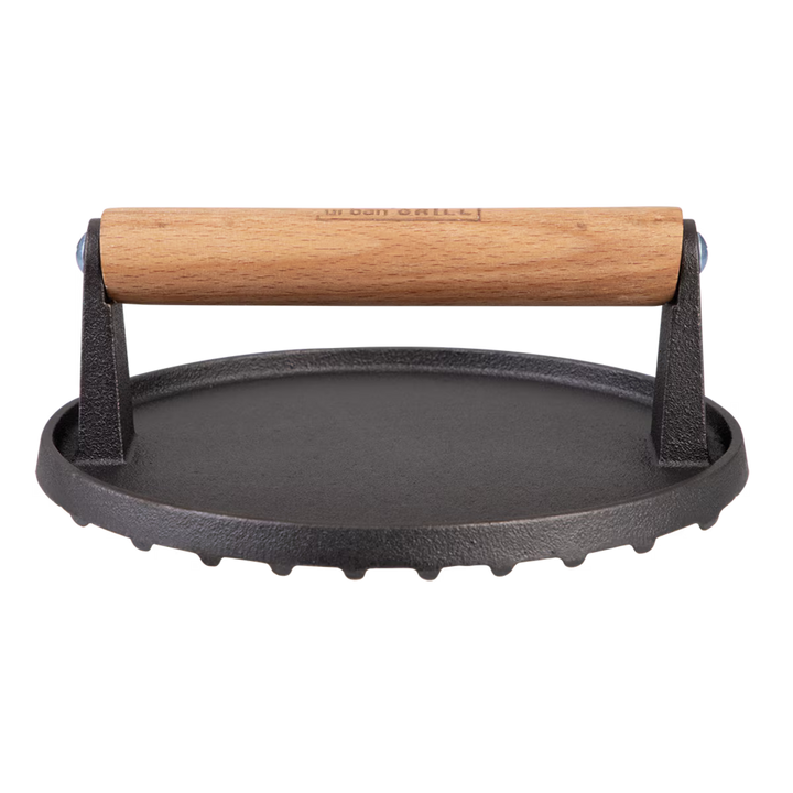 Cast iron grill press with wooden handle on a white background