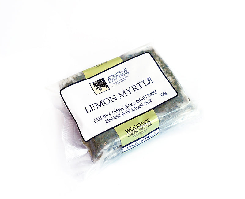 A wedge of woodside chevre with lemon myrtle in packaging on a white background 