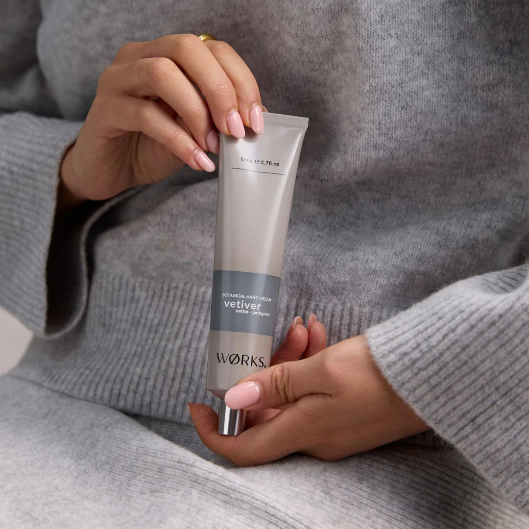 Person holding a tube of &