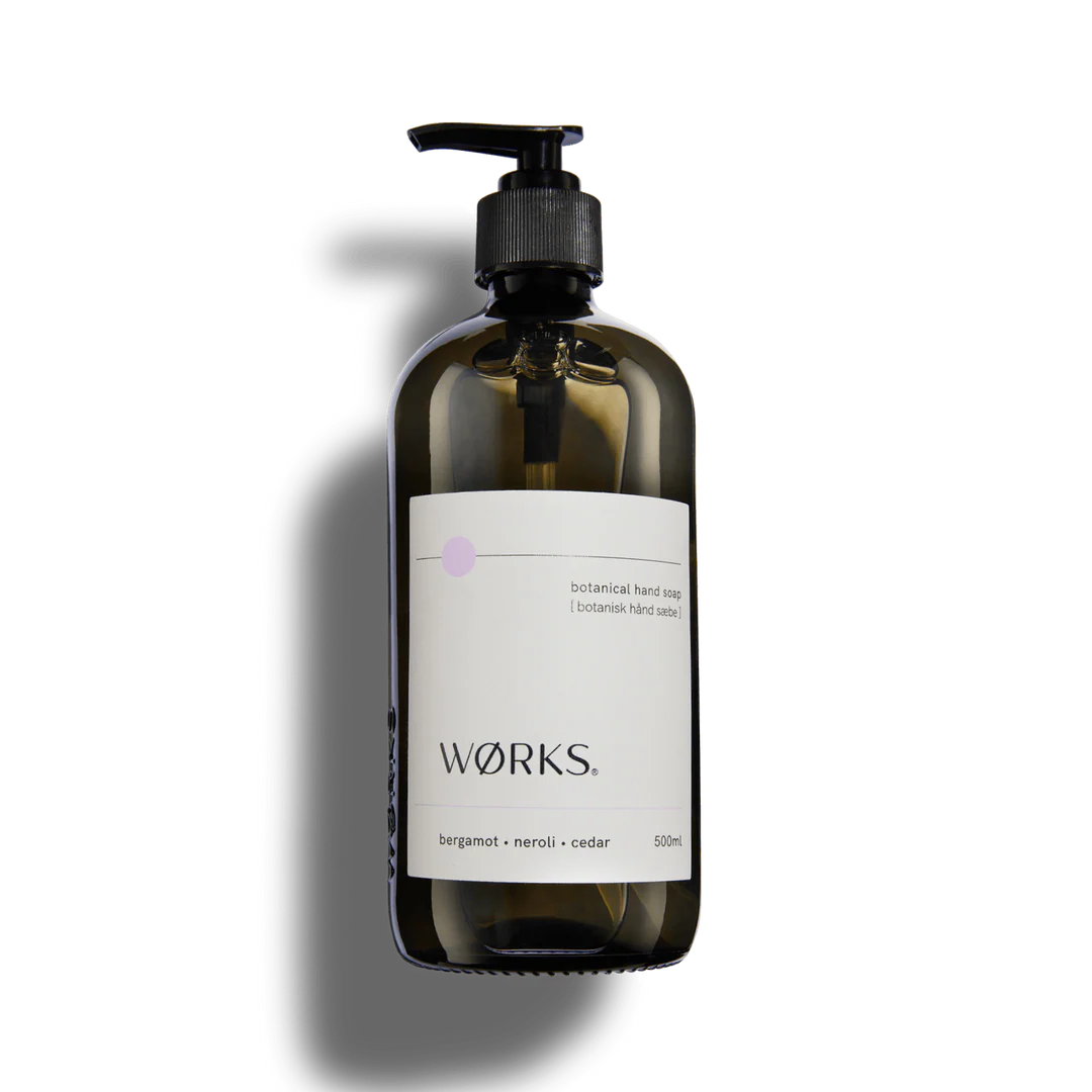 A glass bottle of hand soap on a white background