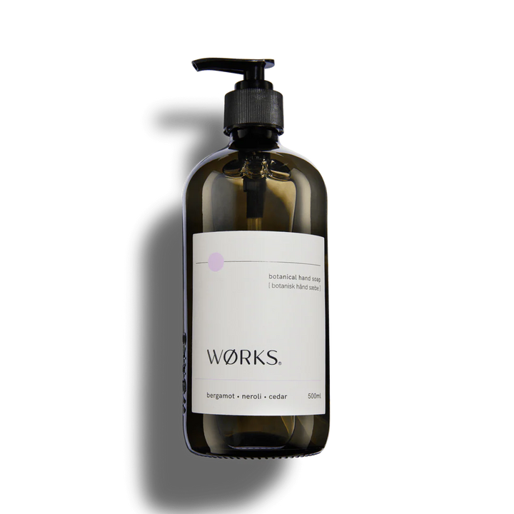 A glass bottle of hand soap on a white background