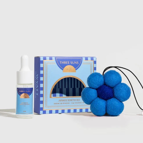 Three Suns product set including a bottle, packaging, and blue flower-shaped item on a white background